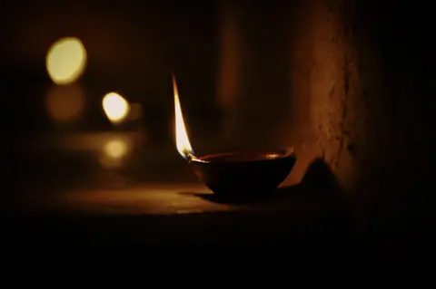 A diya burning in the dark